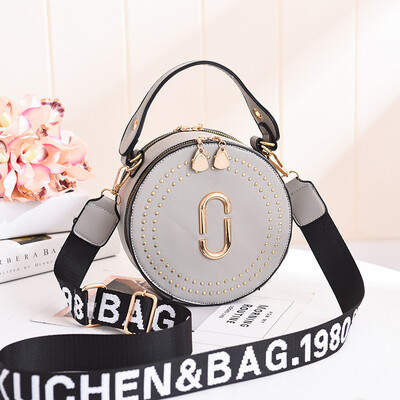 

Fashion rivet small round bag portable Korean version of the lady bag shoulder diagonal wide shoulder strap small bag