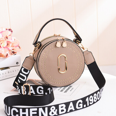 

Fashion rivet small round bag portable Korean version of the lady bag shoulder diagonal wide shoulder strap small bag