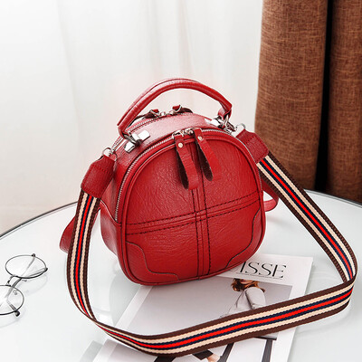 

A girl with a double shoulder bag a broadband shoulder bag a Korean version of a backpack a girl slanted a small round bag and