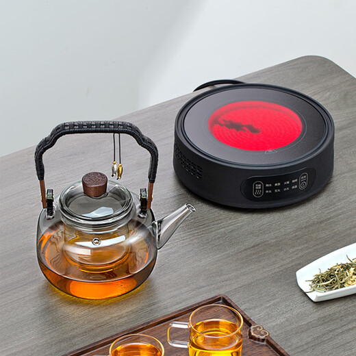 Gold inlaid jade tea making set, electric ceramic stove, glass tea kettle, tea making set, household fully automatic tea making around the stove, leaves start to fall