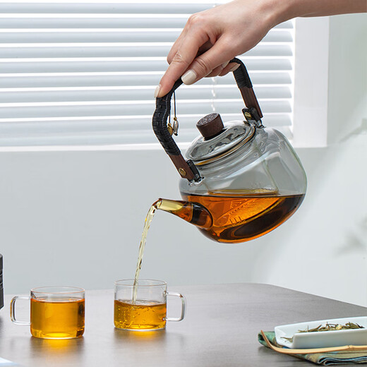 Gold inlaid jade tea making set, electric ceramic stove, glass tea kettle, tea making set, household fully automatic tea making around the stove, leaves start to fall