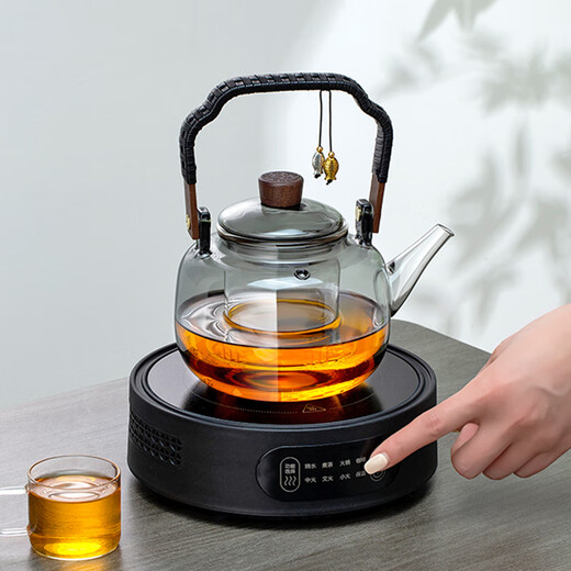 Gold inlaid jade tea making set, electric ceramic stove, glass tea kettle, tea making set, household fully automatic tea making around the stove, leaves start to fall