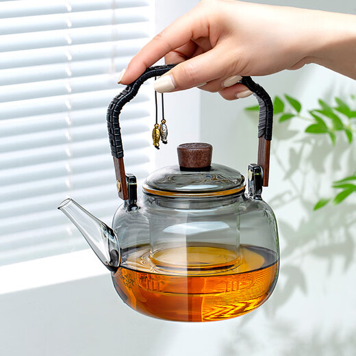 Gold inlaid jade tea making set, electric ceramic stove, glass tea kettle, tea making set, household fully automatic tea making around the stove, leaves start to fall