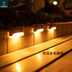 Solar lights, garden lights automatically light up at night, solar decorative wall lights, home outdoor waterproof garden step lights, balcony stairs, fence lights, warm light LED lights (black shell) 4 pieces (4 pieces without nail glue)